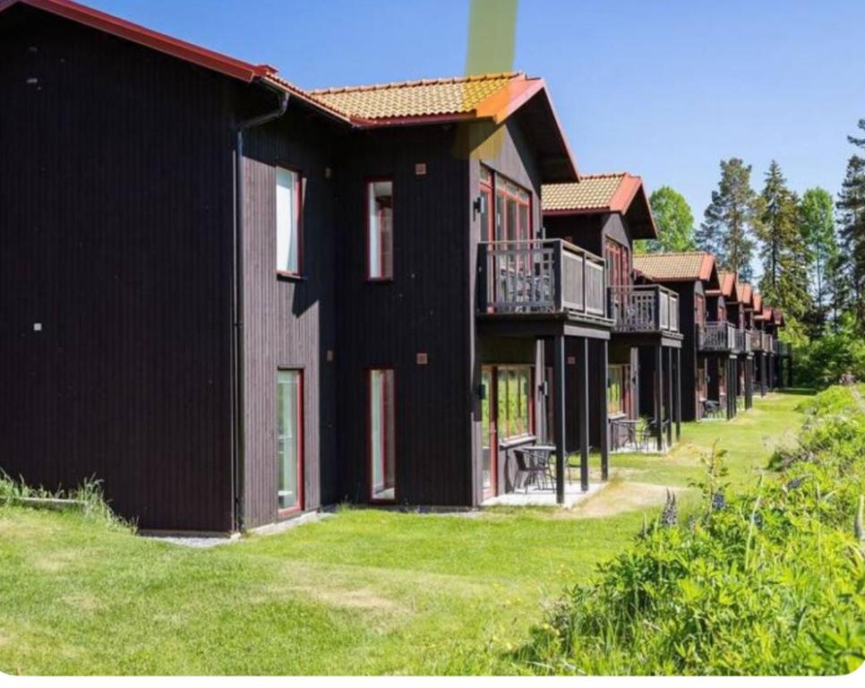 a row of houses with balconies on a lawn at Lisa Lodge i Järvsö Ski and bike in and out in Järvsö