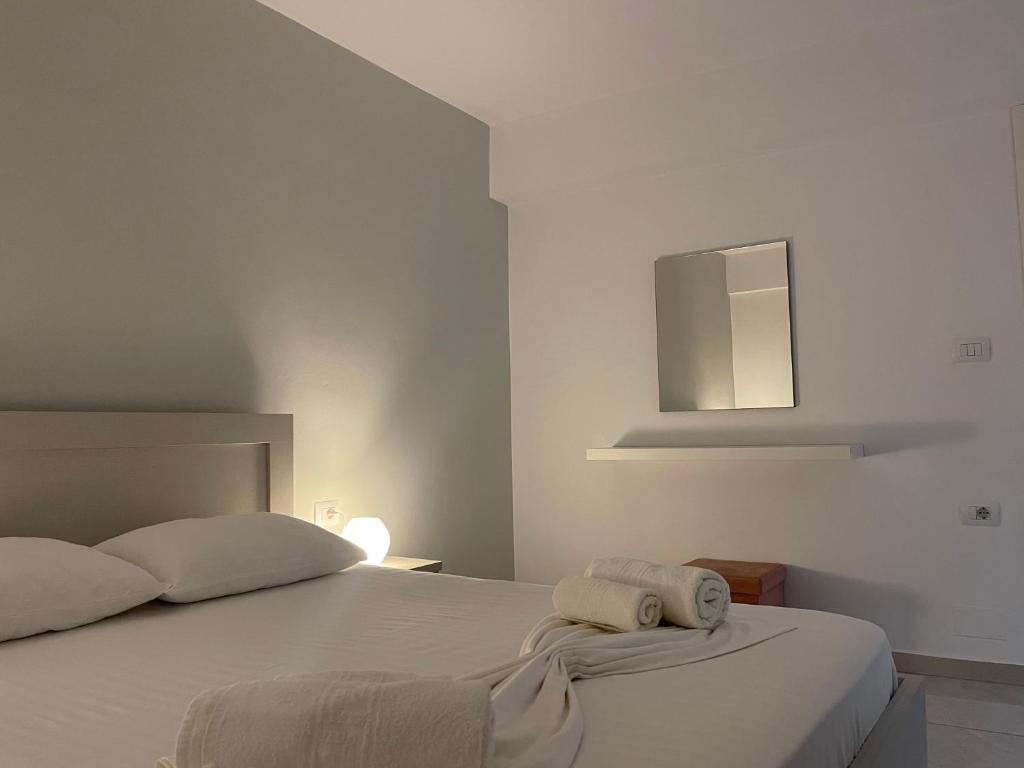 a bedroom with a bed with two towels on it at Villa Angelina Ksamil in Ksamil