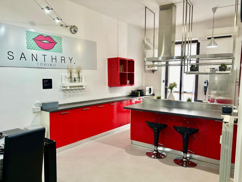 a kitchen with red cabinets and a counter top at Santhry House in Turin