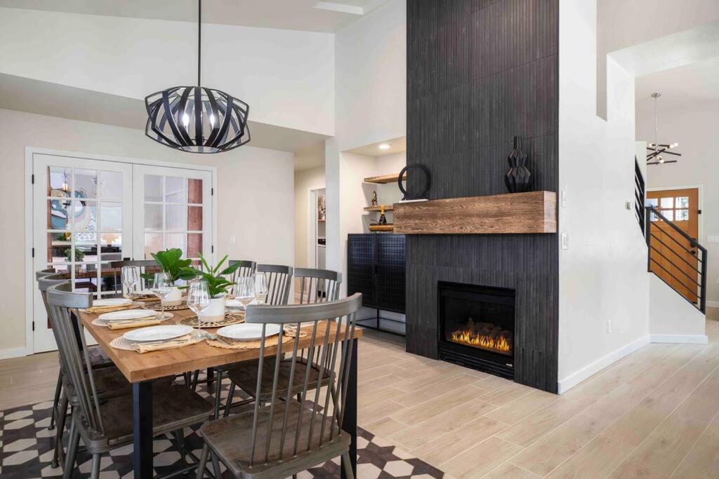 a dining room with a table and a fireplace at The Rock Trail House+Renovated+Modern+Fireplace+EV+Nice Yard in Flagstaff