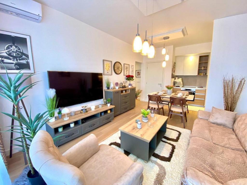 a living room with a couch and a tv at Bray Relax Home 3 in Farsala