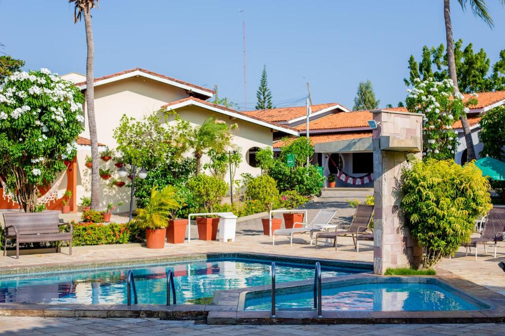 a swimming pool in front of a house at Hotel Pousada do Buriti in Barreirinhas