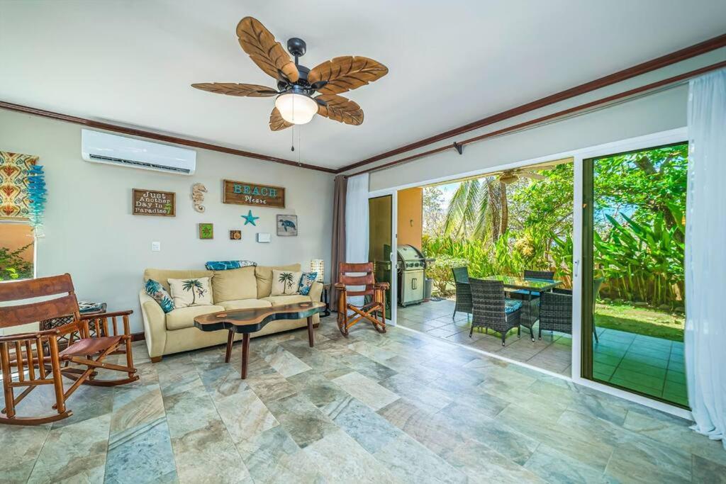 a living room with a couch and a ceiling fan at Beautiful Beachfront 2br Condo, With Full Kitchen in Tamarindo