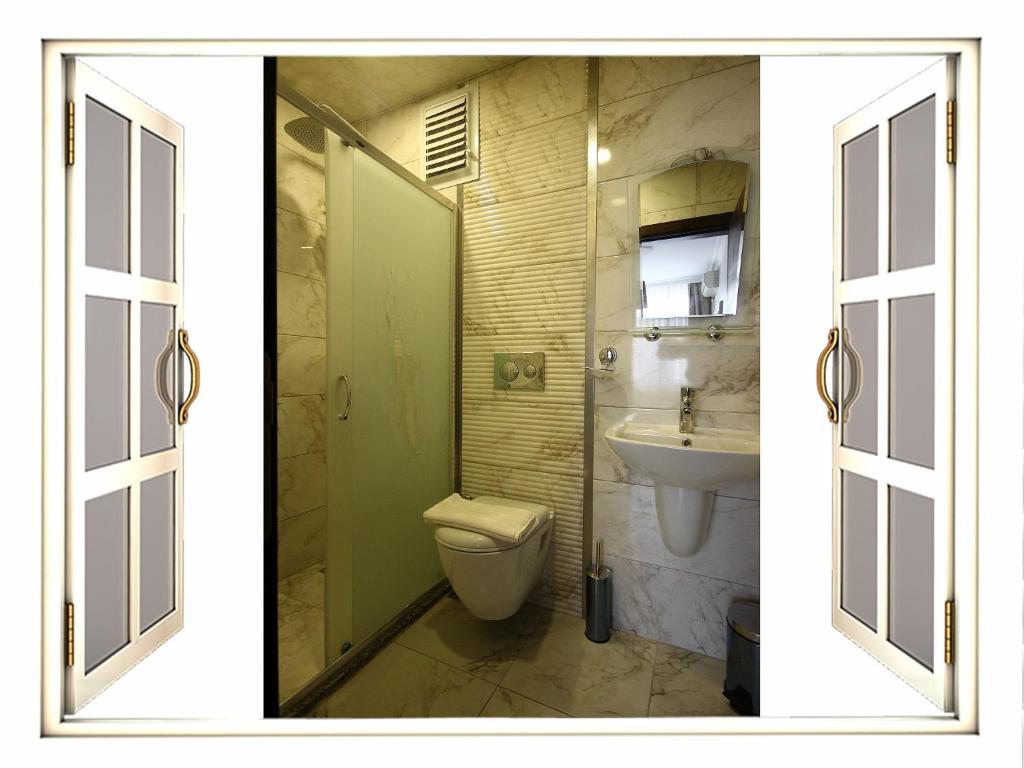 a bathroom with a toilet and a sink at Venus Hotel Taksim in Istanbul