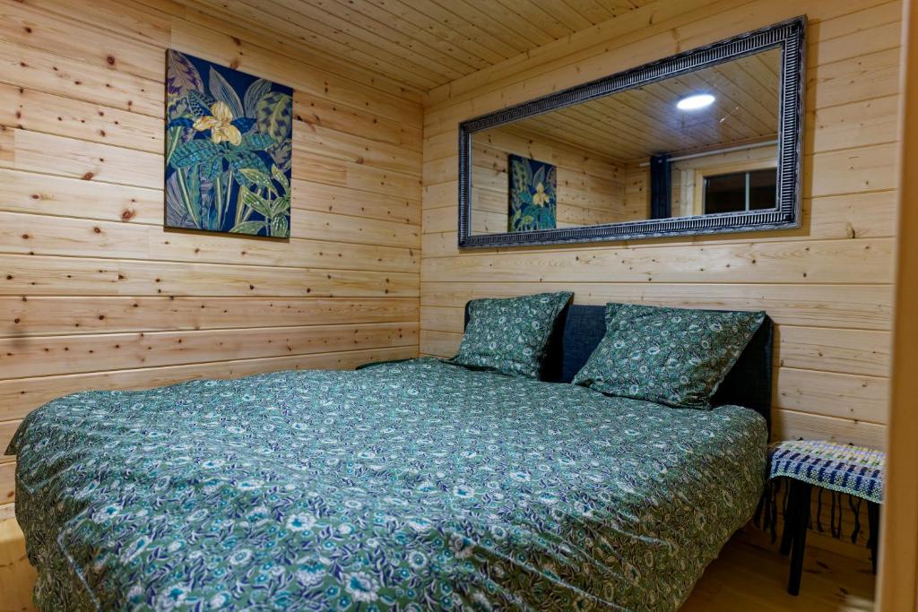 a bedroom with a bed in a wooden room at Autour de l'étang 86 in Bourbourg