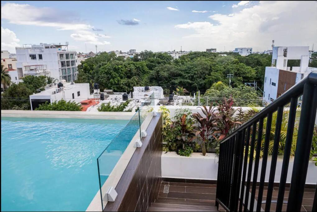 a balcony with a view of a swimming pool at Fast WIFI/5 min beach/Private Parking in Playa del Carmen