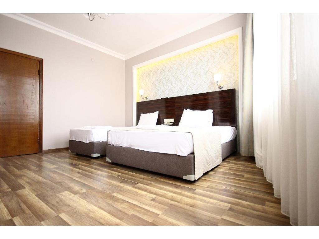 a bedroom with a large bed and a wooden floor at Venus Hotel Taksim in Istanbul