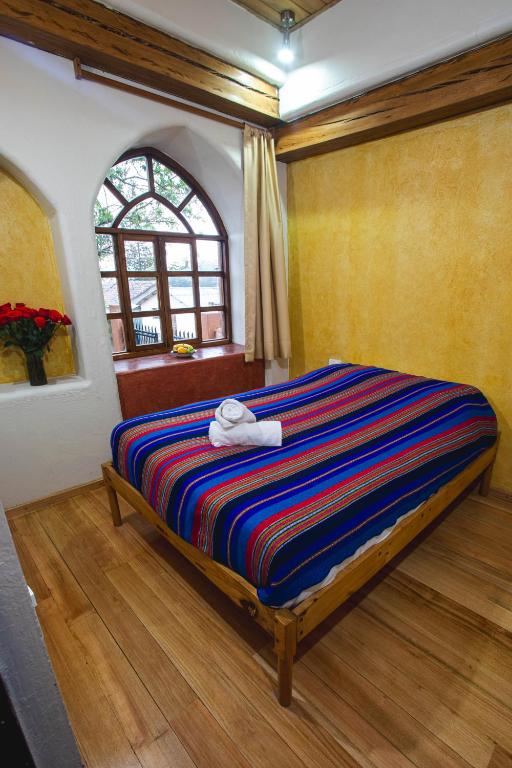 Postel nebo postele na pokoji v ubytování Llullu Llama Mountain Lodge