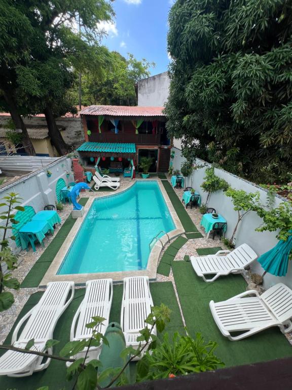 a pool with chaise lounge chairs and a resort at Ladeira de Olinda in Olinda