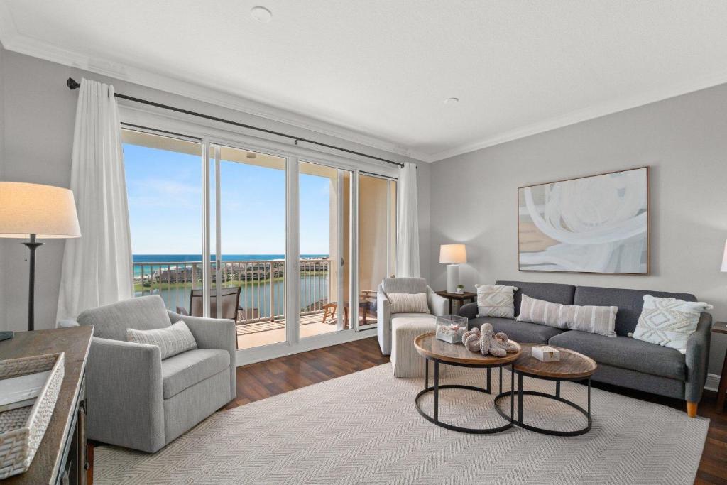 a living room with a couch and chairs and a large window at Ariel Dunes II 1106 in Destin