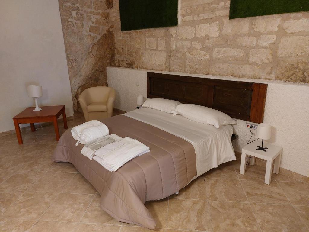 a bedroom with a large bed and a chair at hotel scaffe in Pennapiedimonte