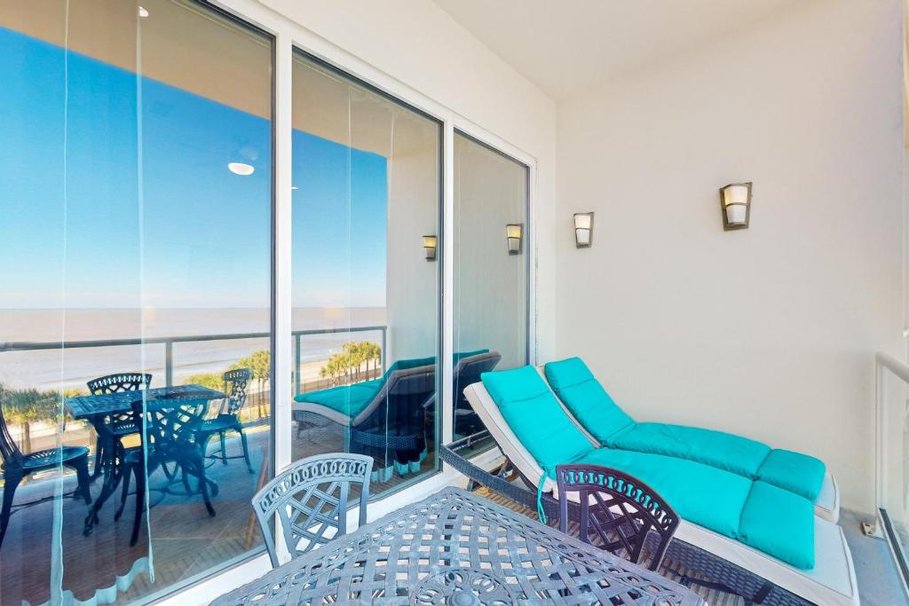 a room with a balcony with a table and chairs at Diamond Beach Resort: Galveston Gem #514 in Galveston