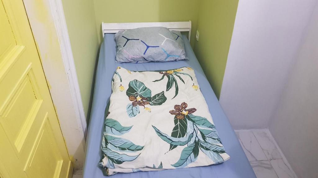 a bed with a blanket and a pillow on it at Just Stay in Warsaw