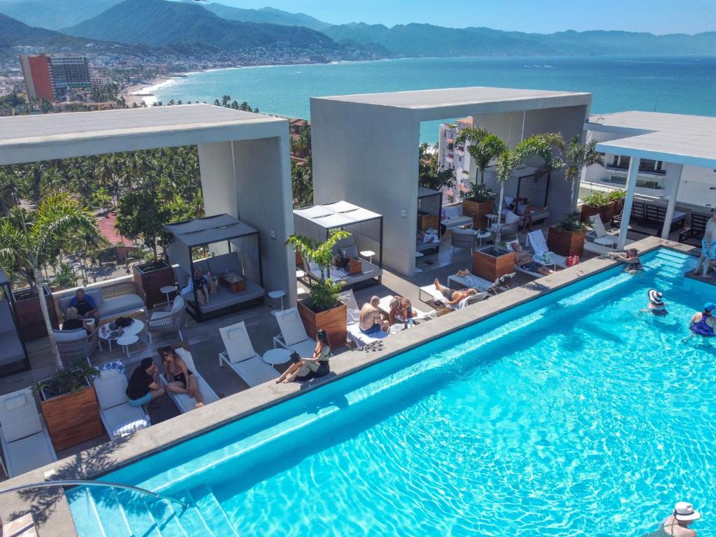 an overhead view of a swimming pool with people in a hotel at Hotel Mio Vallarta Unique & Different- Adults Only in Puerto Vallarta