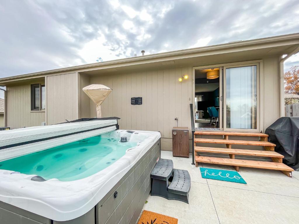 a large hot tub on the patio of a house at New 3 bd 2 bath Hot tub in Omaha