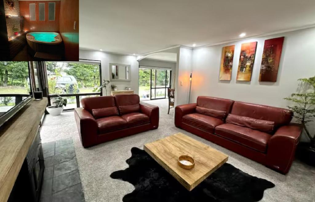 a living room with two leather couches and a coffee table at Bluegum Cottage 