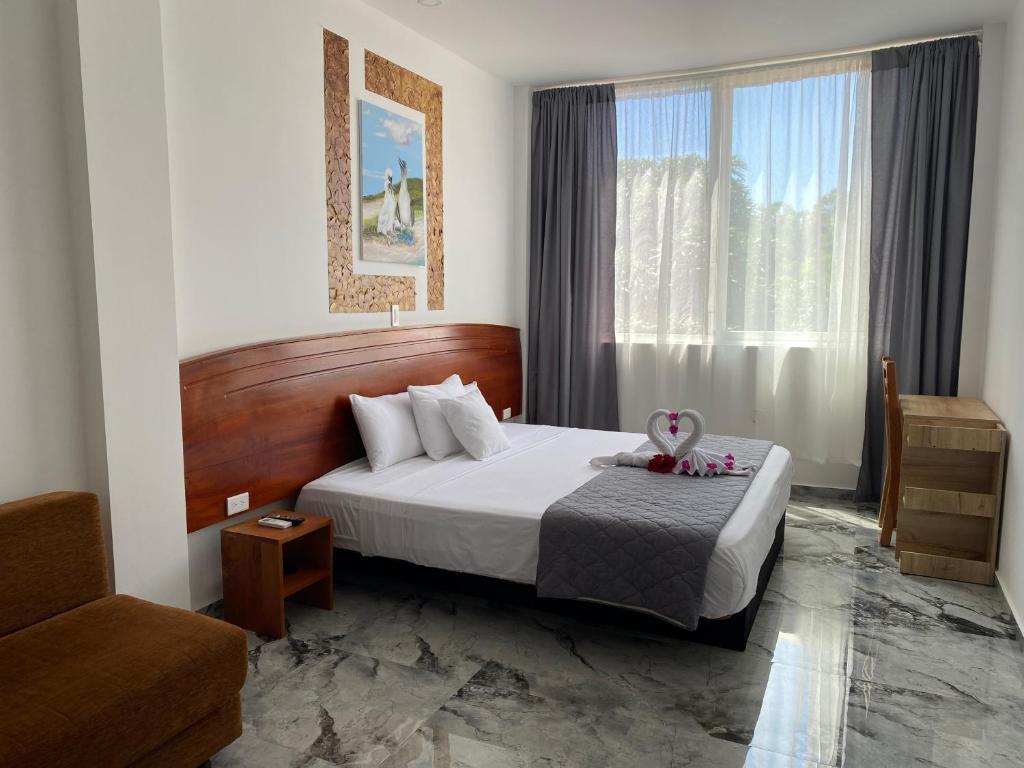 a hotel room with a bed and a window at Patty House Galapagos in Puerto Ayora