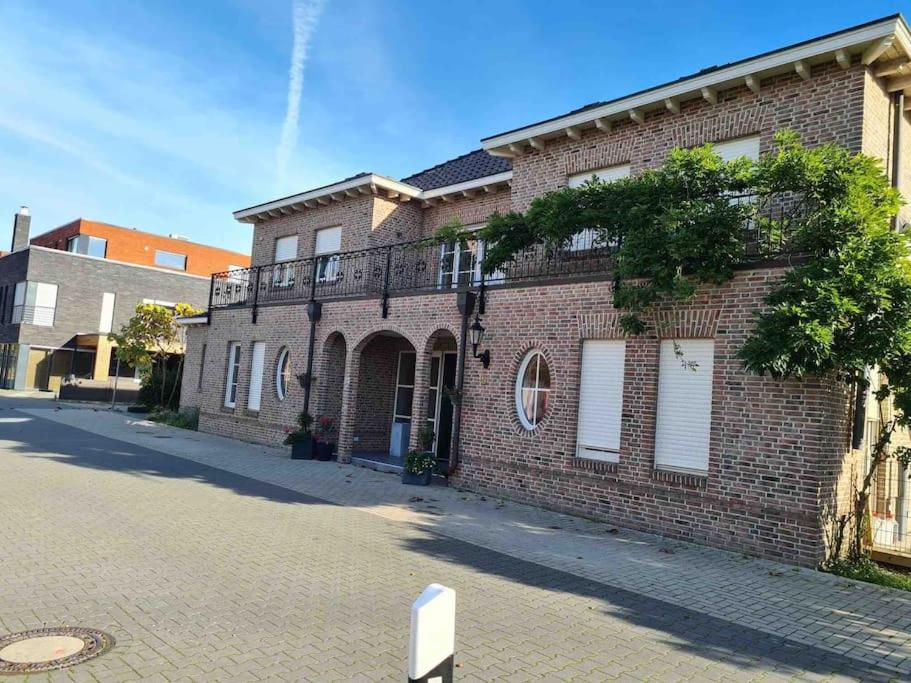a brick building with a balcony on a street at Privatunterkunft in Gronau in Spechtholzhock