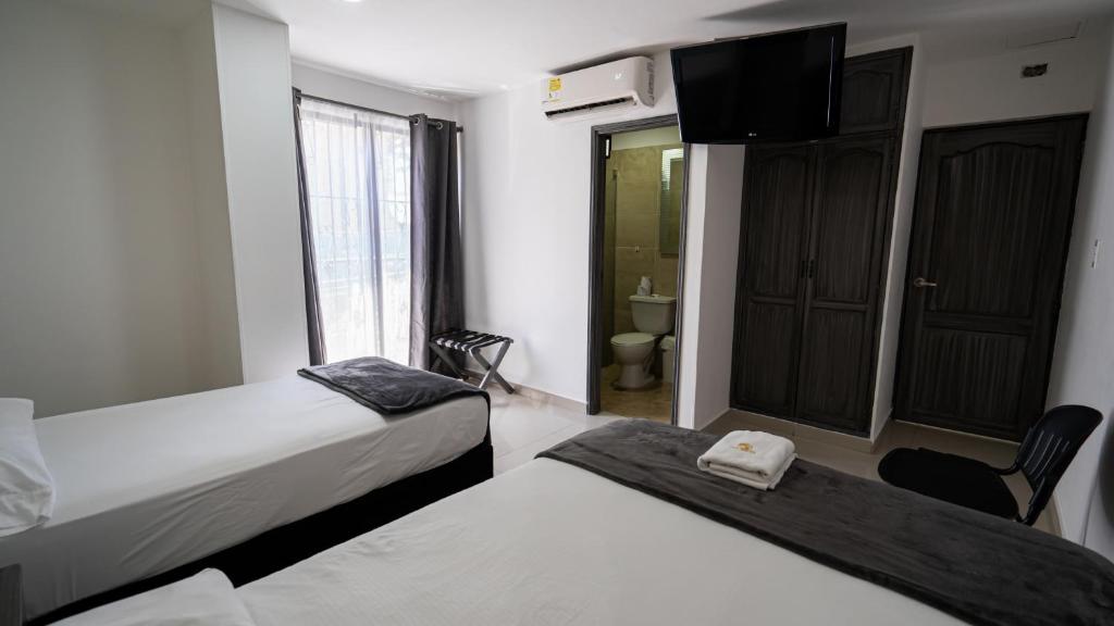 Postel nebo postele na pokoji v ubytování Hotel Tayromar