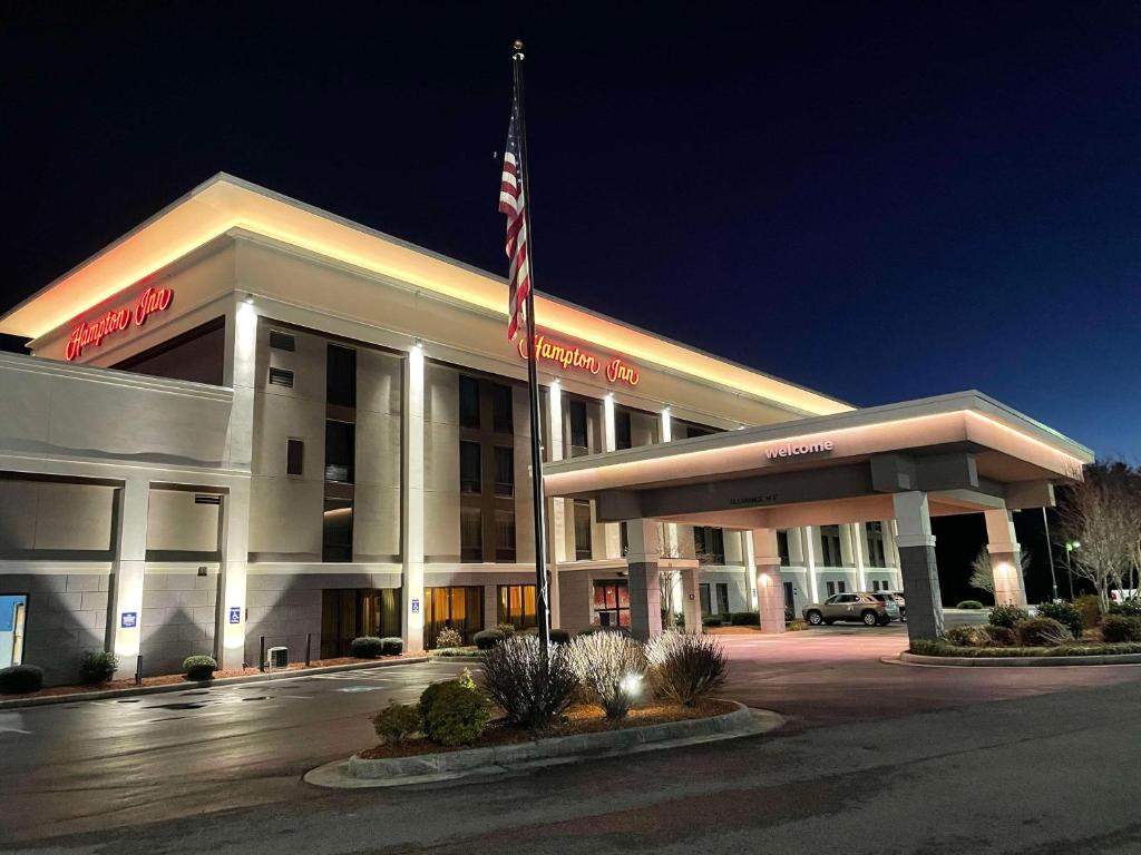 a building with an american flag in front of it at Hampton Inn - Hillsville in Hillsville