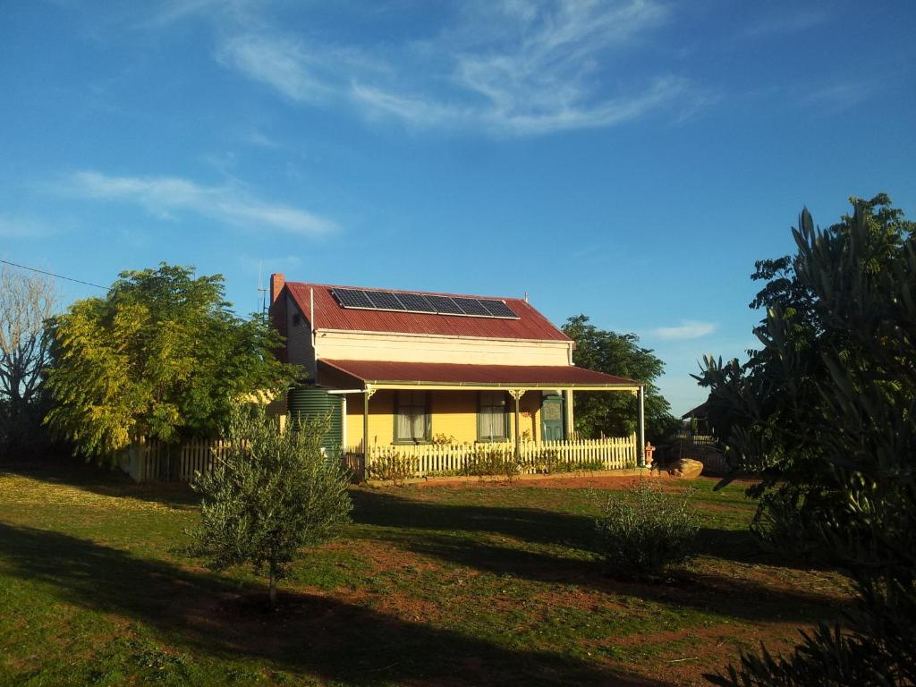 una casa con paneles solares en el techo en Gum Paddock Country Cottage, en Broken Hill