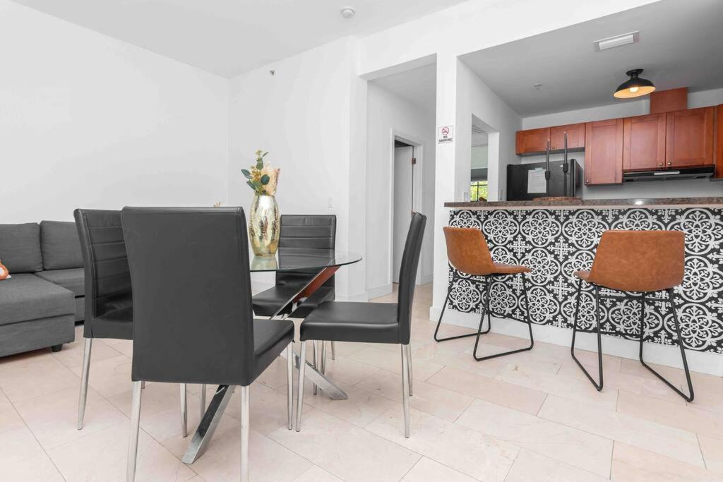a kitchen and dining room with a table and chairs at 1-BR Apartment Downtown Miami - Heart of Wynwood and Midtown in Miami