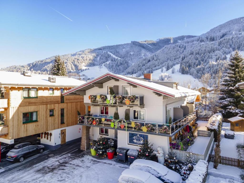 a house in the mountains with snow on the ground at Winter Chalet Kaprun in Kaprun