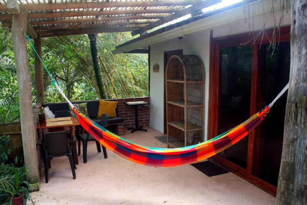 a colorful hammock hanging from a house at Casa Ariana, Acepto Mascota in Ayampe