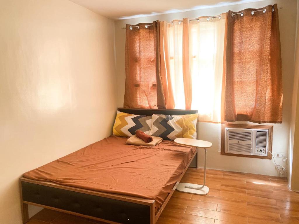 a small bed in a room with a window at Seawind Davao City Condo in Davao City