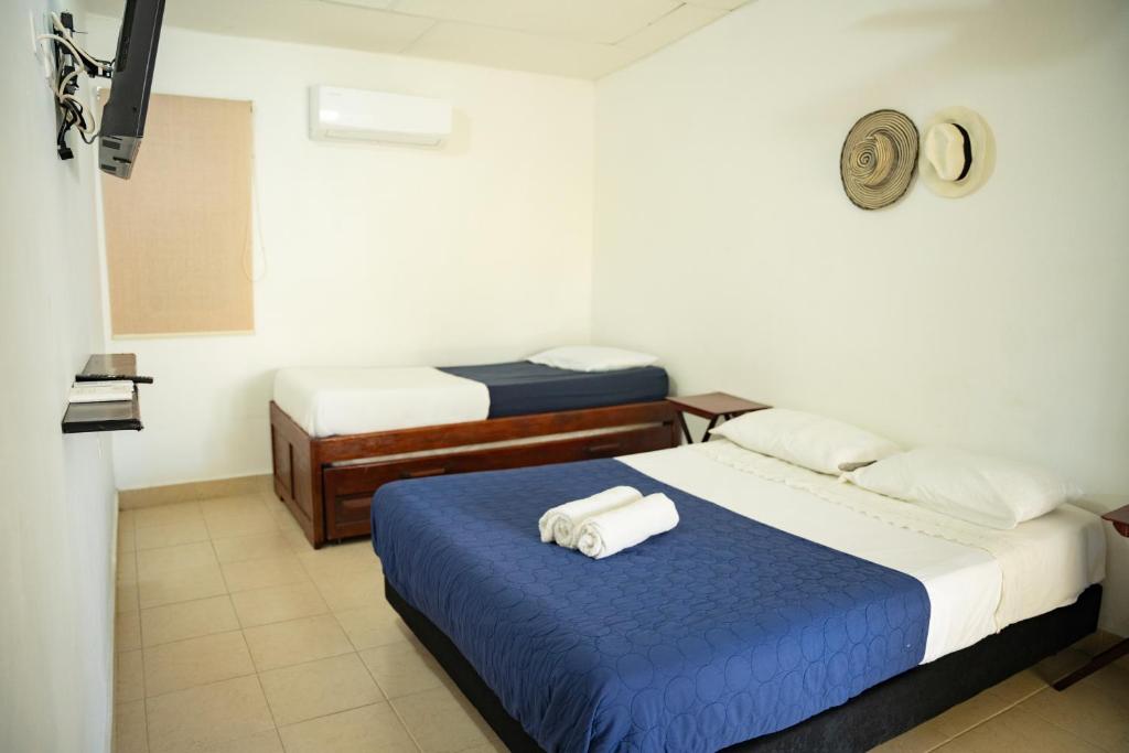 Postel nebo postele na pokoji v ubytování Hostal del Mar - Tolu
