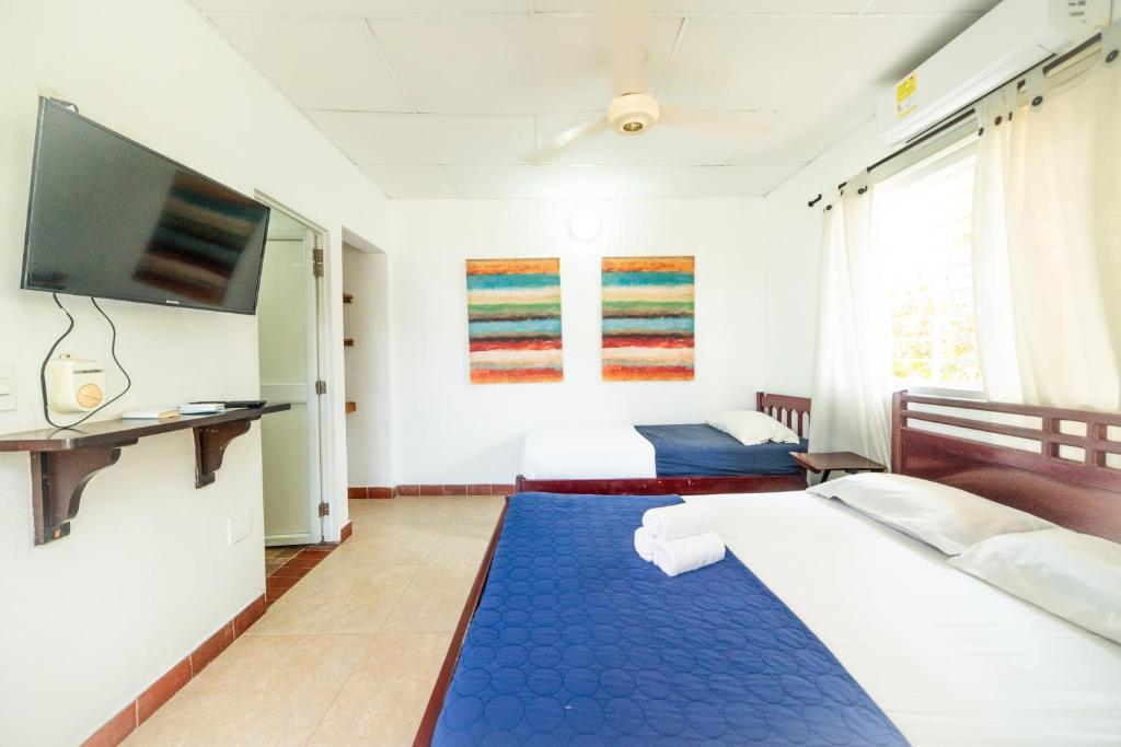 Postel nebo postele na pokoji v ubytování Hostal del Mar - Tolu