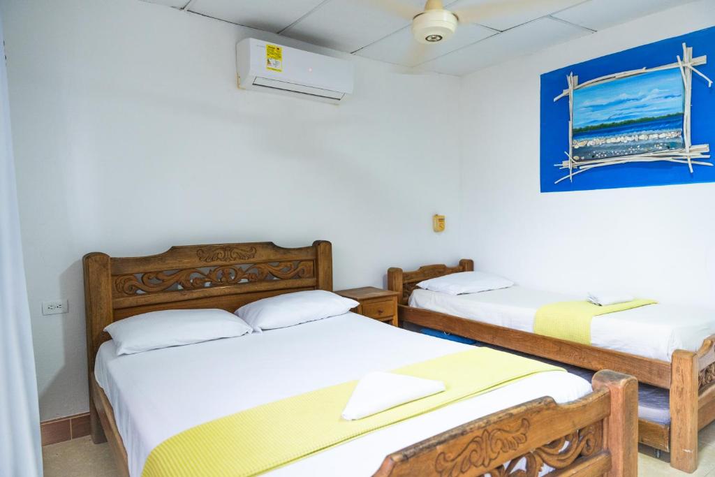 Postel nebo postele na pokoji v ubytování Hostal del Mar - Tolu