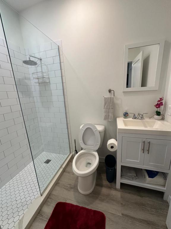 een badkamer met een douche, een toilet en een wastafel bij 19 North Apt 323 in West Bay