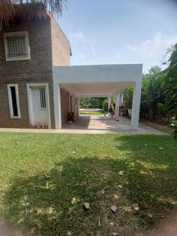 a building with a white pavilion outside of it at Casa en Pueblo Esther in Esther