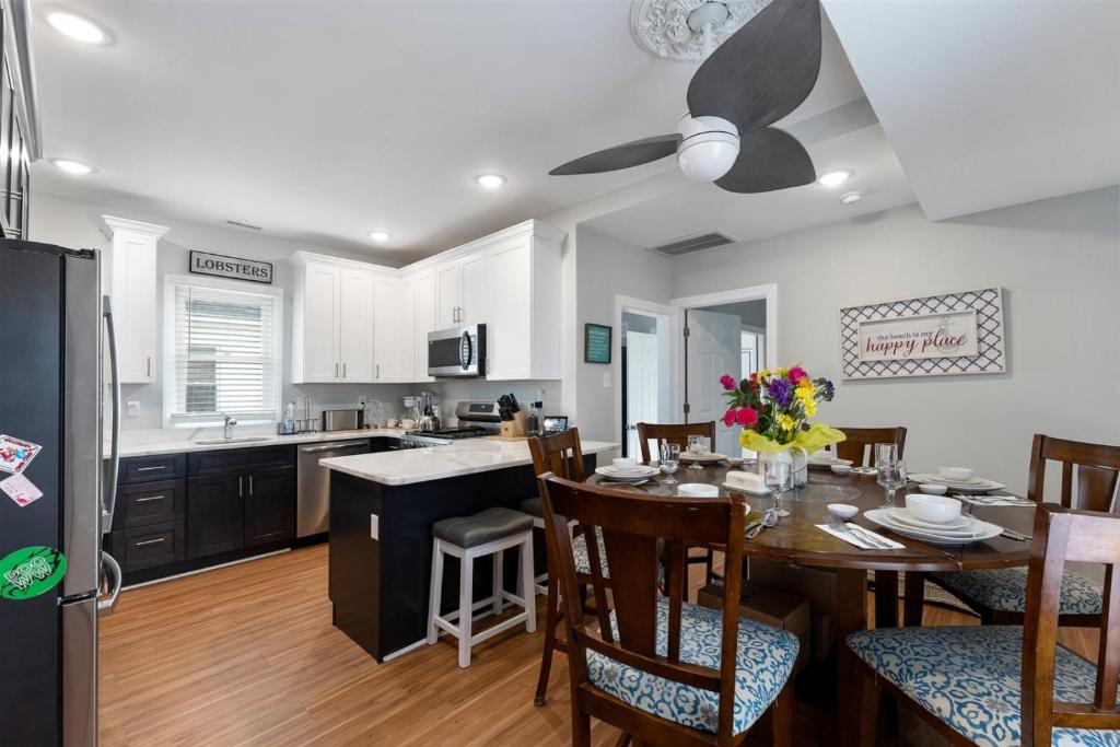 a kitchen and dining room with a table and chairs at 232 W Pine Ave 4 Beds, 2 Baths in Wildwood