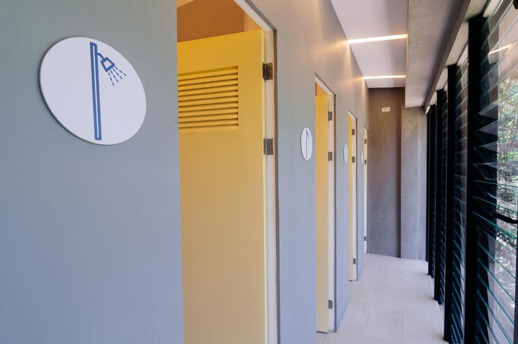 a hallway in a hospital with a yellow and white wall at Spin Designer Hostel - El Nido in El Nido