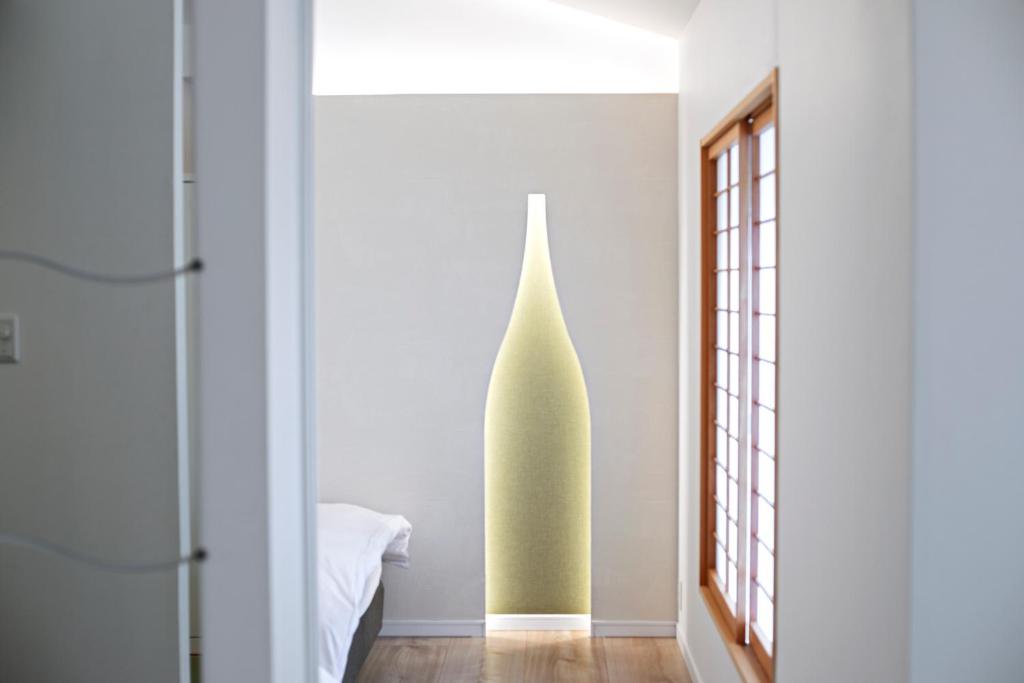 Postel nebo postele na pokoji v ubytování Forest Guardian Hotel 京都御所西