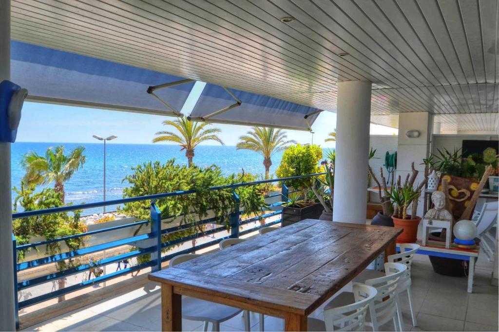 シッチェスにあるWATER FRONT DUPLEX by Hello Homes Sitgesの海の景色を望むバルコニー(テーブル付)