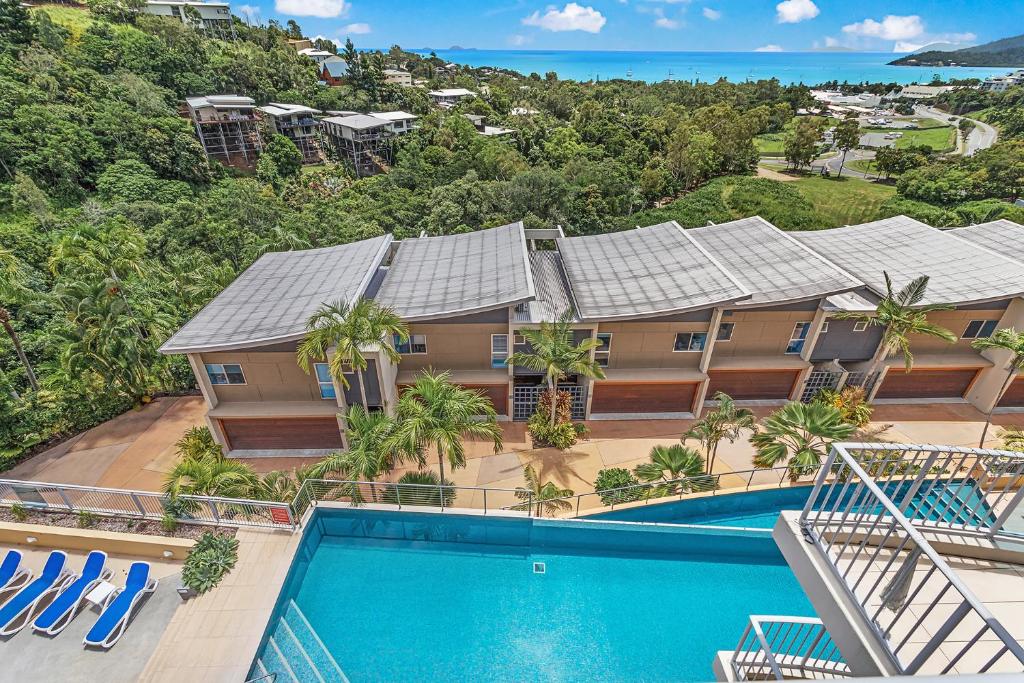 an aerial view of a house with a swimming pool at Coral View at Azure Sea in Airlie Beach