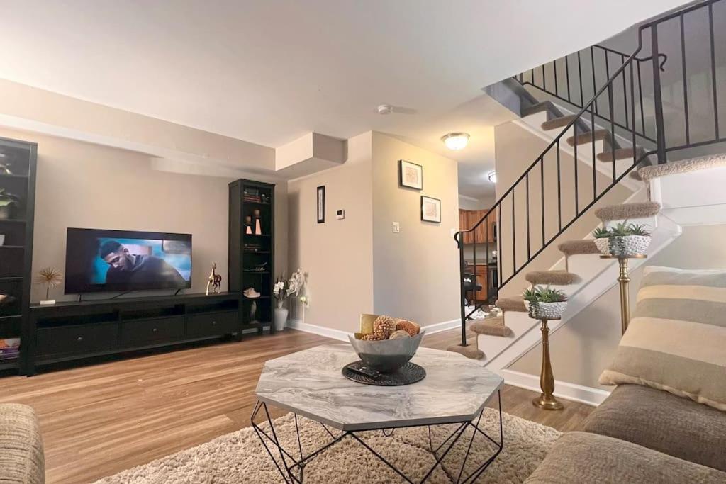 a living room with a couch and a tv at Entire Home in North Potomac in Potomac