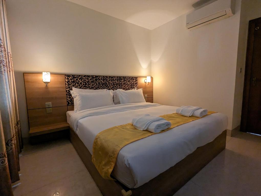 Postel nebo postele na pokoji v ubytování 中青秋果酒店 True Go Hotel