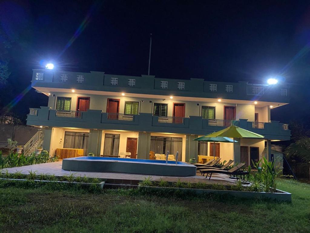 a large house with a pool in front of it at night at Kep Orchid Boutique Resort in Kep