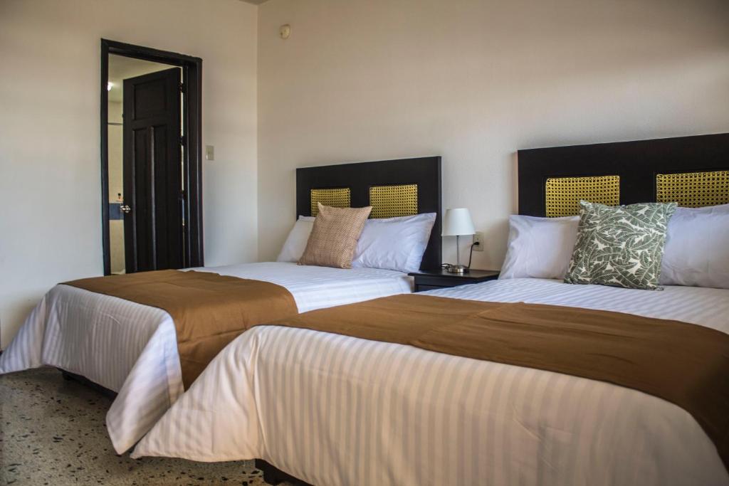 Postel nebo postele na pokoji v ubytování Múcara hotel