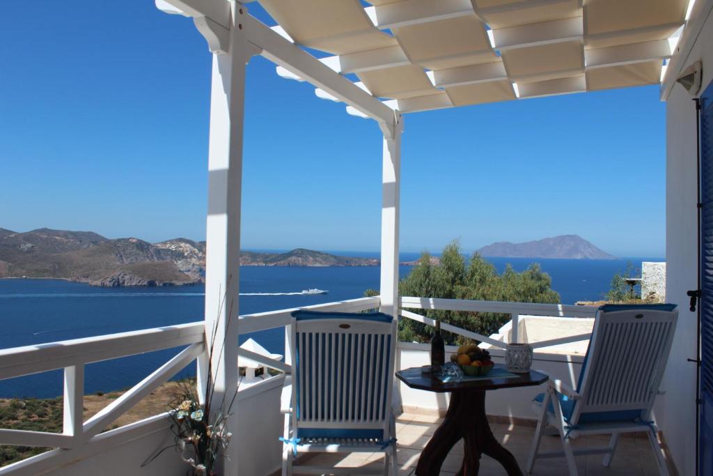 a porch with chairs and a view of the water at Studios Betty in Plaka Milou