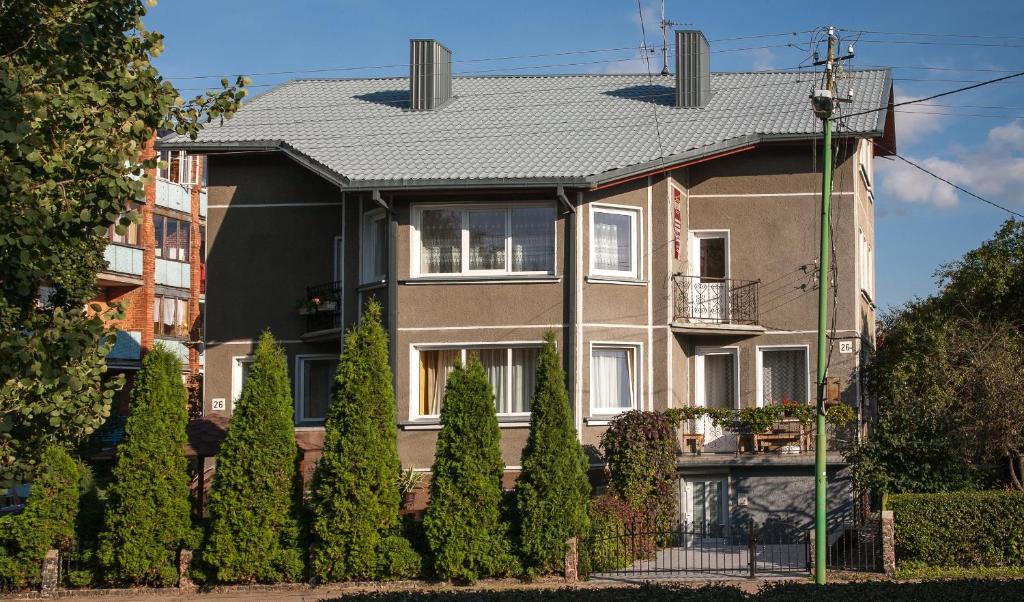 a large house with trees in front of it at Irenos Svetaine in Palanga