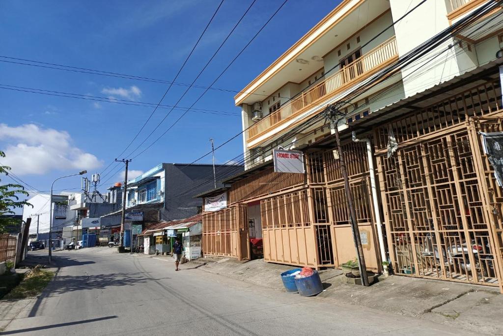 an empty street with a building with iron gates at OYO 93764 Homestay Citra in Kendari