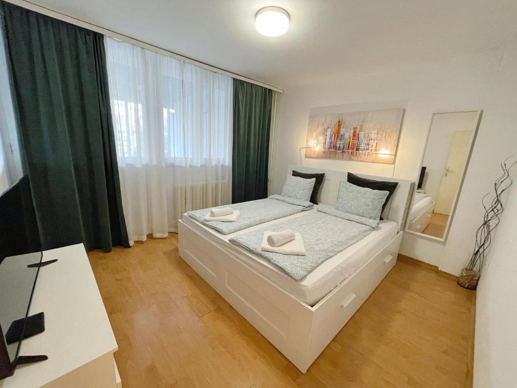 a bedroom with a bed and a large window at Cherry Apartment Arena in Belgrade