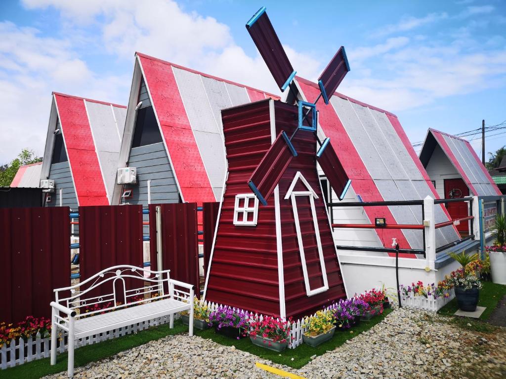 a house that is painted to look like a house at Red Triangle Cottage Roomstay in Kampong Kemaman