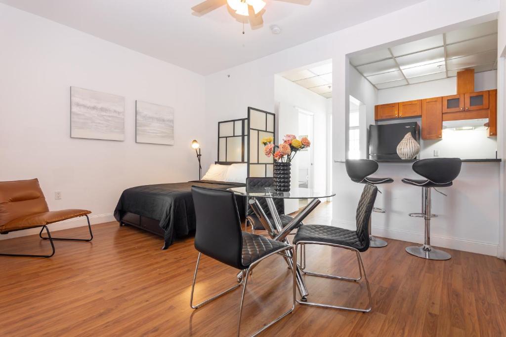 a bedroom with a bed and a table and chairs at 1-BDRM Apartment with Balcony - Heart of Downtown and Wynwood in Miami