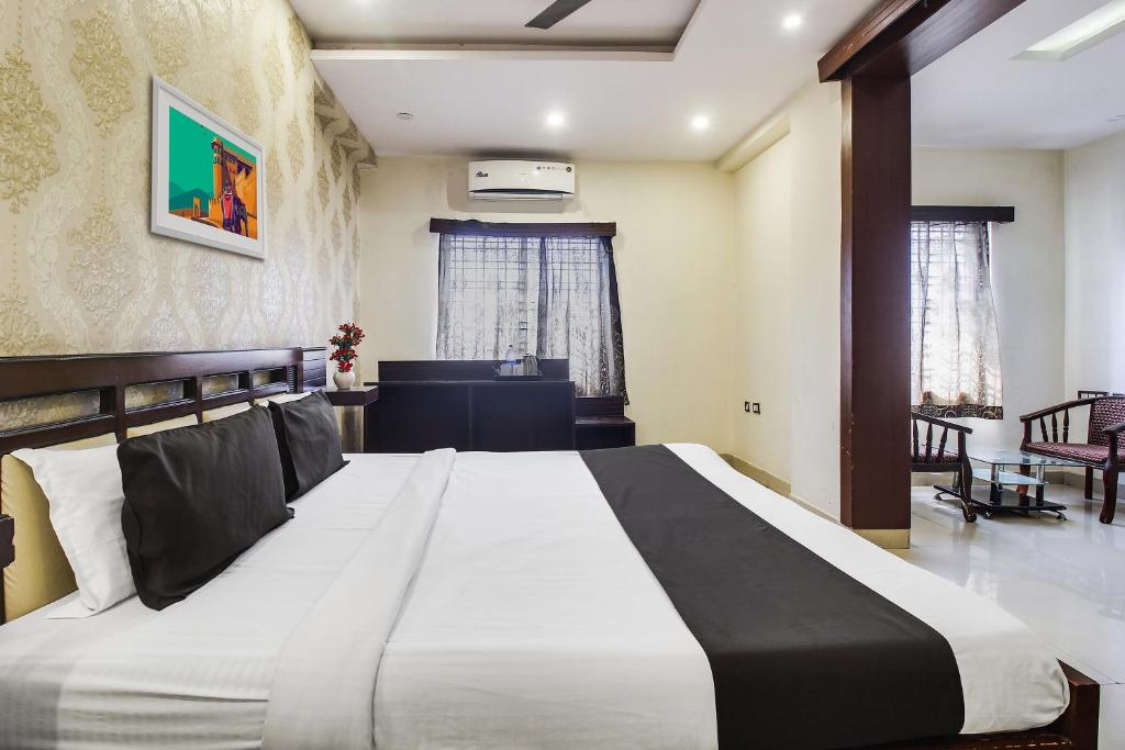 a bedroom with a large bed in a room at Flagship Grand Sandarshini Inn Near MGBS Bus station in Hyderabad